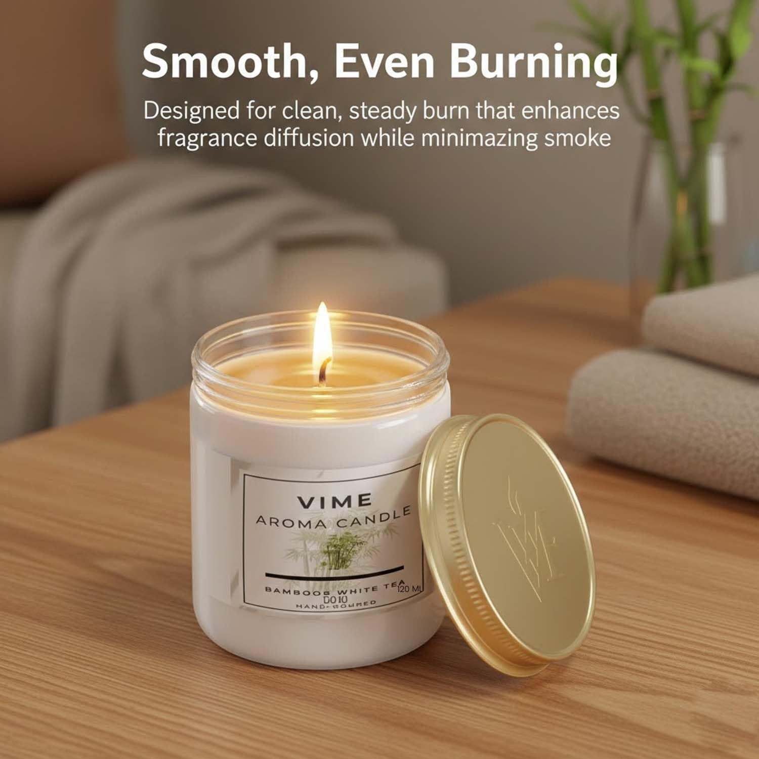 ViMe Bamboo & White Tea scented candle in a white jar with a gold lid, burning with a steady flame.