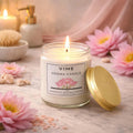 ViMe Serenity Bloom Lotus aroma candle in a glass jar with a gold lid, burning with a soft flame.